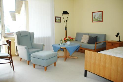 a living room with a couch and chairs and a table at Hotel-Café "Schauinsland" in Horn-Bad Meinberg