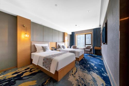 Ένα ή περισσότερα κρεβάτια σε δωμάτιο στο INJOY Apartment