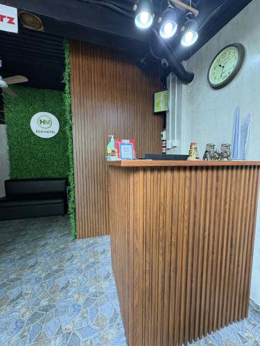a bar in a restaurant with a clock on the wall at HM Eco Hotel NAIA in Manila