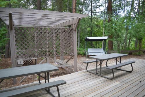 a picnic table and a chair on a wooden deck at Chalet Continental Motel in Valemount