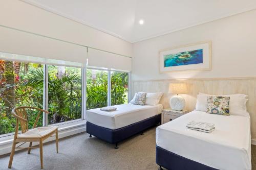 a bedroom with two beds and a window at Mirage Resort Villa 456 with access to Sheraton Facilities in Port Douglas