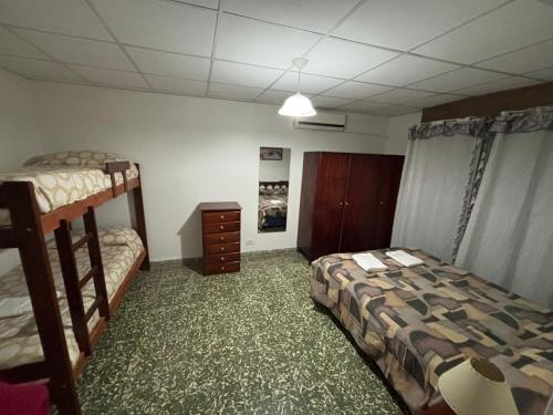 a bedroom with two bunk beds and a dresser at Casa Familiar in San Rafael
