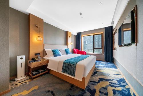 Ένα ή περισσότερα κρεβάτια σε δωμάτιο στο INJOY Apartment