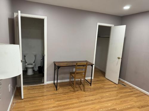 a table and a chair in a room with a toilet at Near To CCBC ESSEX Private Room 201 in Parkville