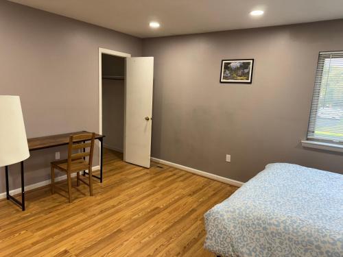 a bedroom with a bed and a desk and a table at Near To CCBC ESSEX Private Room 201 in Parkville