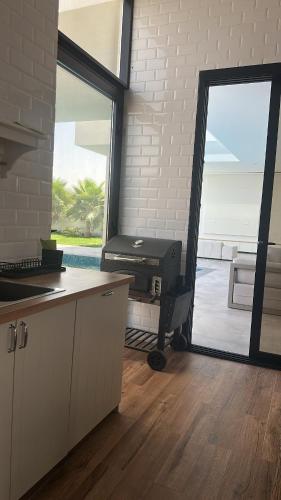 a kitchen with a large door leading to a patio at Orchid Boutique Chalet in Barka