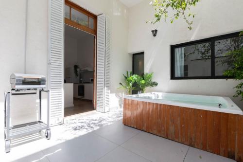 a large bathroom with a tub and a large window at Fliphaus GuateHaus Palermo Soho 25 pax in Buenos Aires