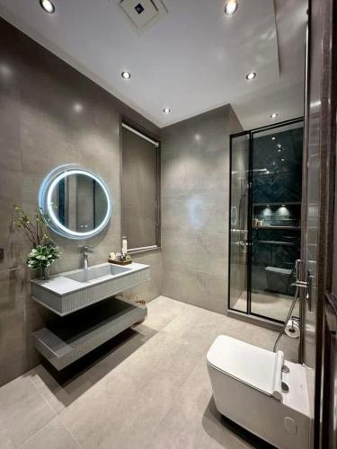 a bathroom with a sink and a tub and a mirror at Family Luxury Lodges in Islamabad