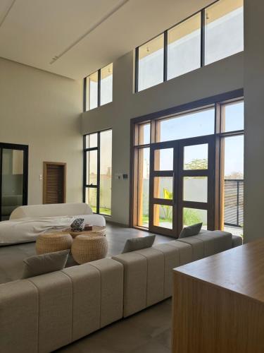 a large living room with two beds and a couch at Orchid Boutique Chalet in Barka