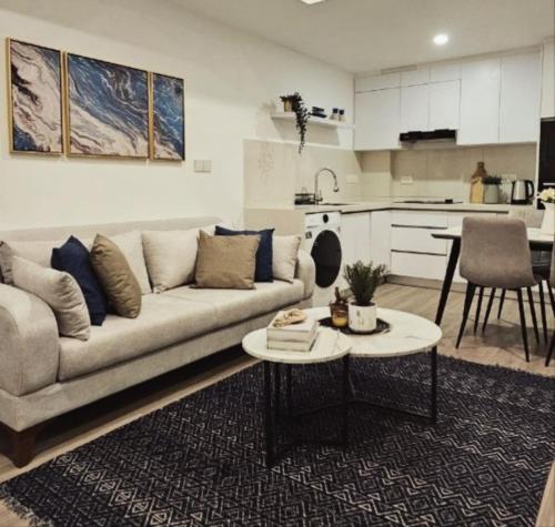 a living room with a couch and a table at Nala Host - 2BR Apartment Seaside Bliss in Hulhumale