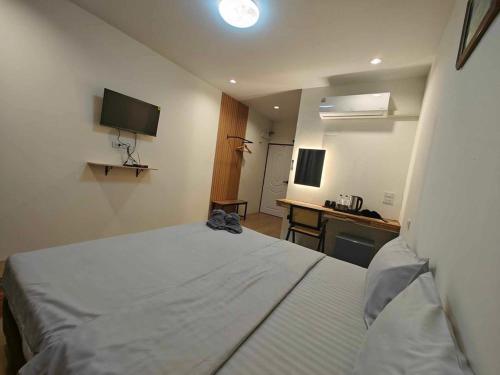 a bedroom with a bed and a desk and a television at Moon lake resort 