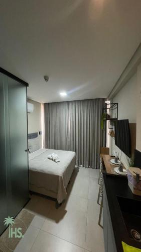 a hotel room with a bed and a sink at Get By Side in João Pessoa