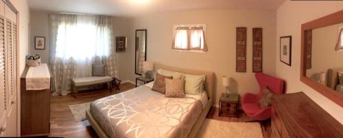 a bedroom with a bed and a red chair at Fantastic Classic Family Home in Boulder