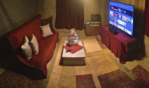 a living room with a red couch and a television at Fantastic Classic Family Home in Boulder