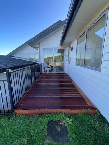 a porch of a home with a wooden deck at Country Inn in Pokeno