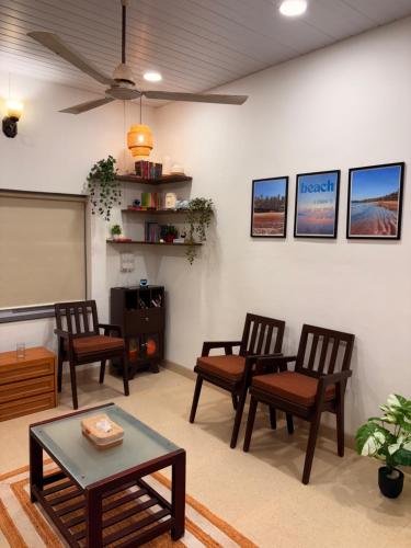 a classroom with chairs and a chalkboard and a table at Annapurna Beach House in Adi