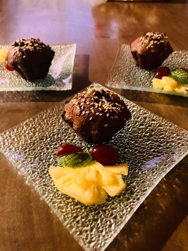 three different types of desserts on plates on a table at Studio Le Prunier in La Plaine des Cafres