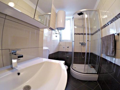 a bathroom with a tub and a shower and a sink at Apartment Adriatic in Split