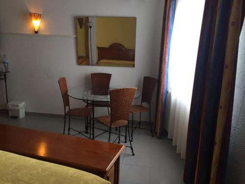 a room with a bed, chair, table and a lamp at Hotel Cims Pas de La Casa in Pas de la Casa