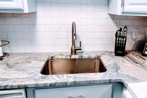 a kitchen counter with a stainless steel sink at Just Imagine! Newly Renovated Ocean View 1BR-1 Ba Condo in Ocean City