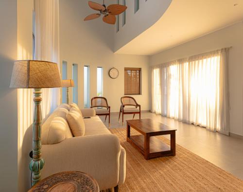 a living room with a couch and a table at Nandi Daybreak - Holiday Homes in Bengaluru