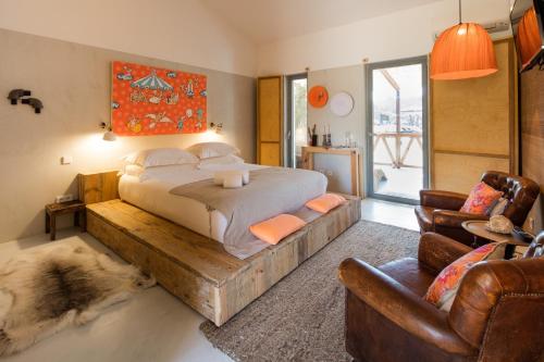 a bedroom with a large bed with a wooden frame at TEIMA, Alentejo SW in São Teotónio