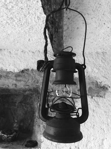 a black lantern hanging from a wall at Il Roccolino in Valsecca