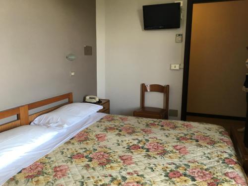 Postel nebo postele na pokoji v ubytování Hotel Plutone
