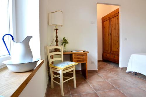 a room with a table and a chair and a desk at Casale Del Gelso in Genzano di Roma