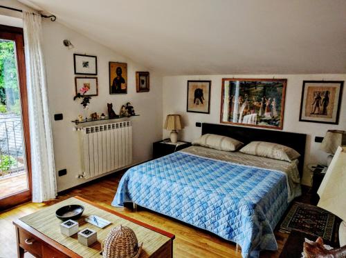 a bedroom with a bed with a blue comforter at Sally's B&B in Carrara