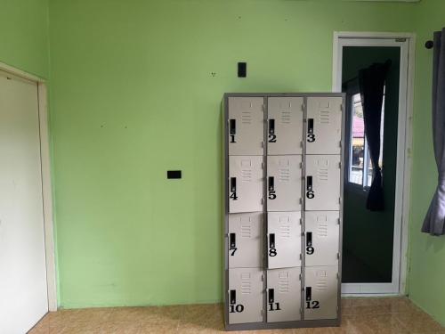 a group of lockers in a room with a door at Khao Sok Jungle Hostel in Khao Sok