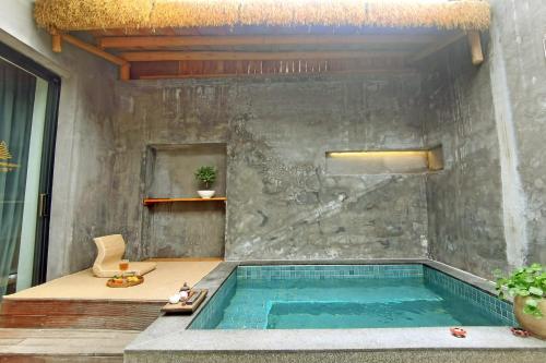 a swimming pool in the middle of a house at Qingyuan Zhilin Hot Spring Bed and Breakfast in Qingyuan