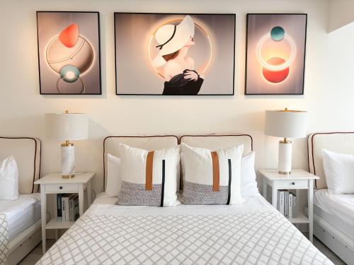 a bedroom with a bed with four pictures on the wall at 樂居 台北 in T'ung-ko