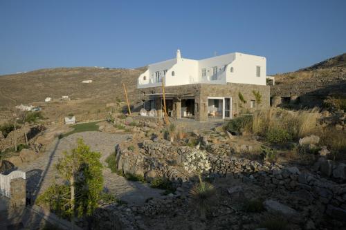 a house on the side of a hill at Ortygia Suites in Mikonos