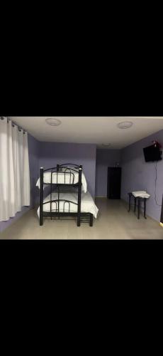 a bedroom with a bunk bed and a table at Cómodo depto cerca del AICM in Mexico City