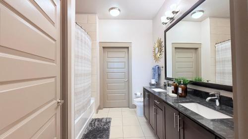 a bathroom with a sink and a mirror at Skyline Stay in Houston