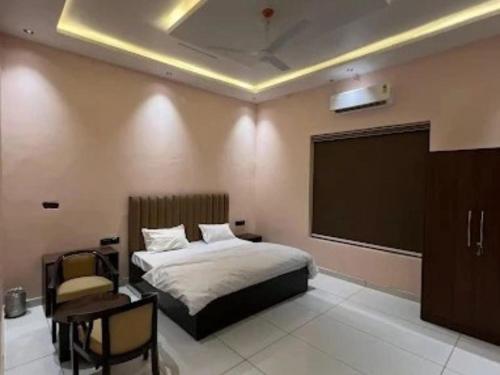 a bedroom with a bed and a projection screen at Mahaveer Dhaba in Shāhābād