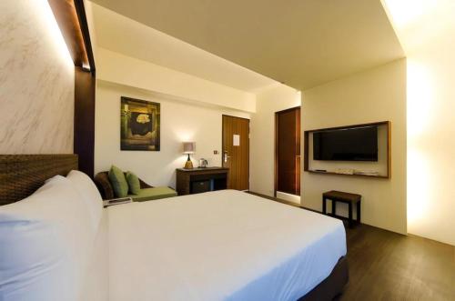 Postel nebo postele na pokoji v ubytování 嬉安平 Si Anping by Hotel Si