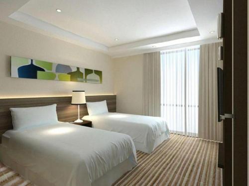 Кровать или кровати в номере Xiamenair Maple Hotel (Xiamen SM City Plaza)