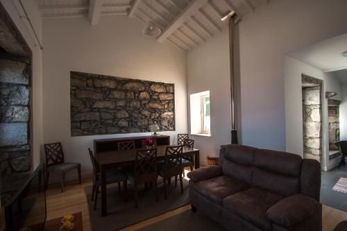 a living room with a couch and a table at Casa do Simão, Açores - Now with hot tub! in Nordeste