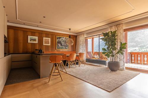 a kitchen and dining room with a table and chairs at Gran Tubla Apartments in Ortisei