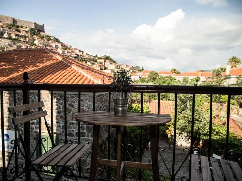 a table and a chair on a balcony at Olive Press Hotel in Mithymna