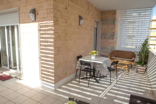 a patio with a table and chairs on a balcony at B&B Aries in Casarano