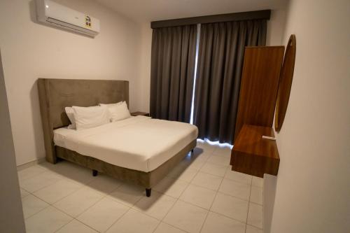 a bedroom with a bed and a window at Luxury Villa Beach Front in Salalah