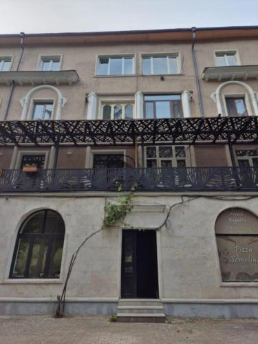 a building with a balcony on top of it at Home in Borjomi in Borjomi