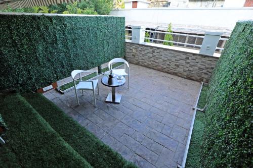 a patio with a table and two chairs on it at The Oriental Residency in Mumbai