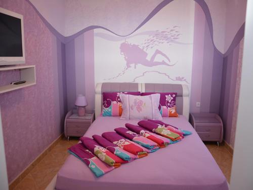 a bedroom with a large bed with a horse on the wall at Apartmani Niksic in Herceg-Novi