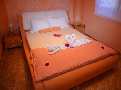 a bedroom with a bed with two towels on it at Apartmani Niksic in Herceg-Novi