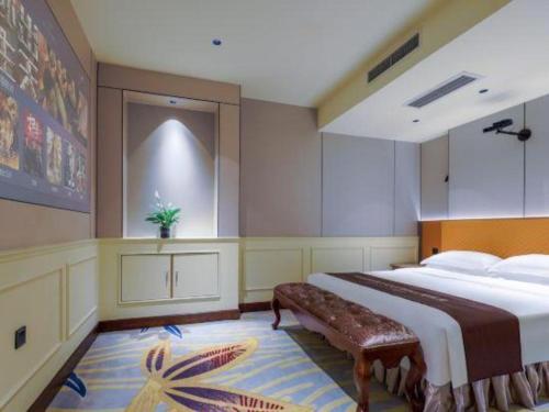 a bedroom with a large bed and a bench at Chengdu Haotian Guotai Hotel in Chengdu