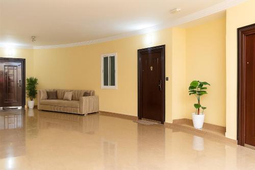 a living room with a couch and a chair at Residence Issrae 1 in Nador